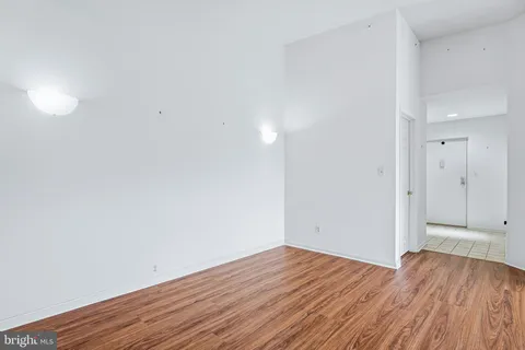 a view of an empty room with wooden floor