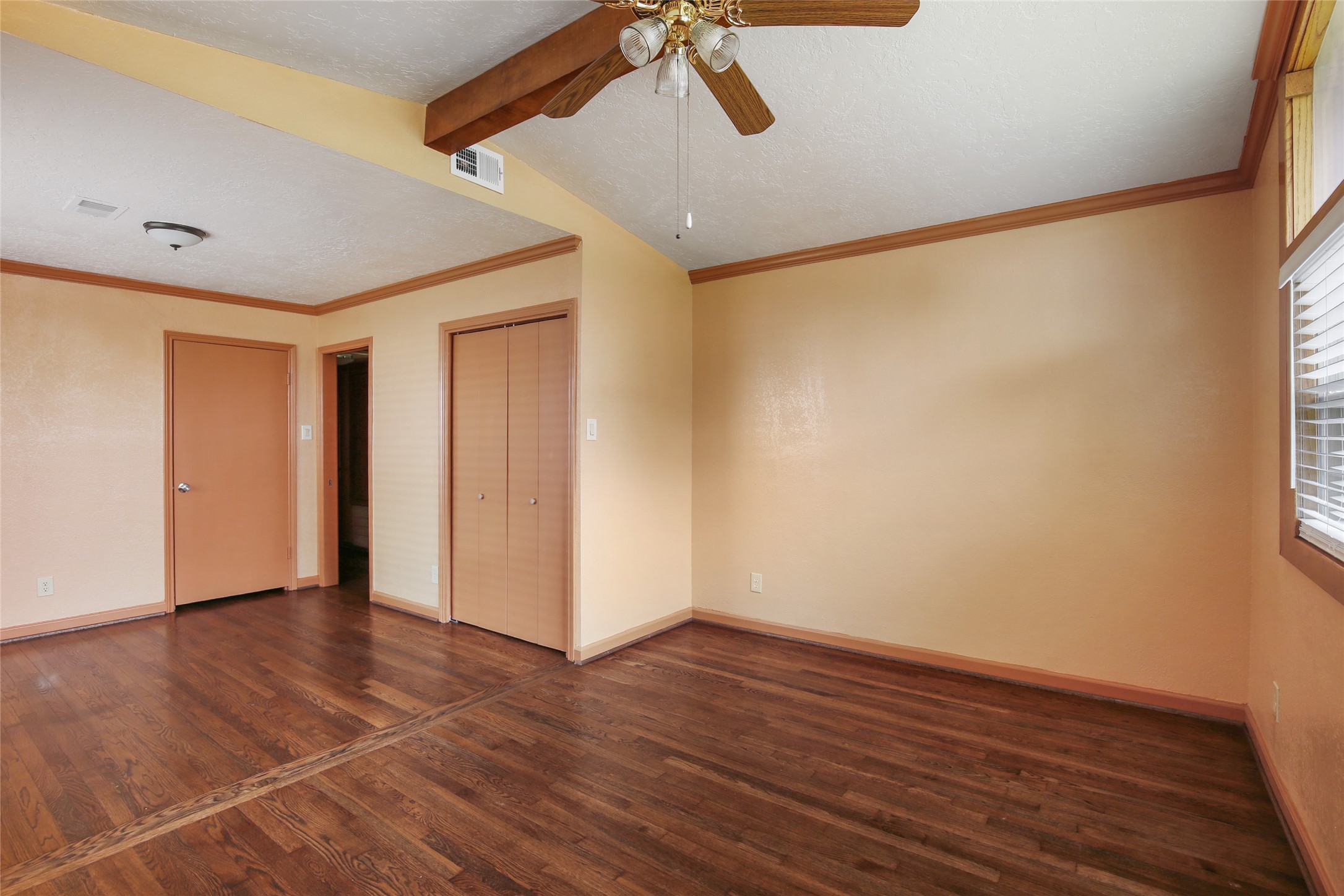 6923 Leader Street Houston, TX 77074 - Photo 5 of 19 a view of an empty room with wooden floor and a window