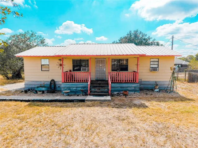 a view of house with backyard space and balcony