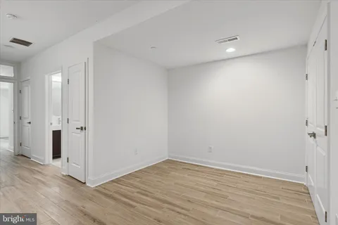 a view of a room with wooden floor