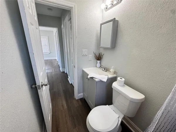 a white toilet sitting next to a bathroom sink