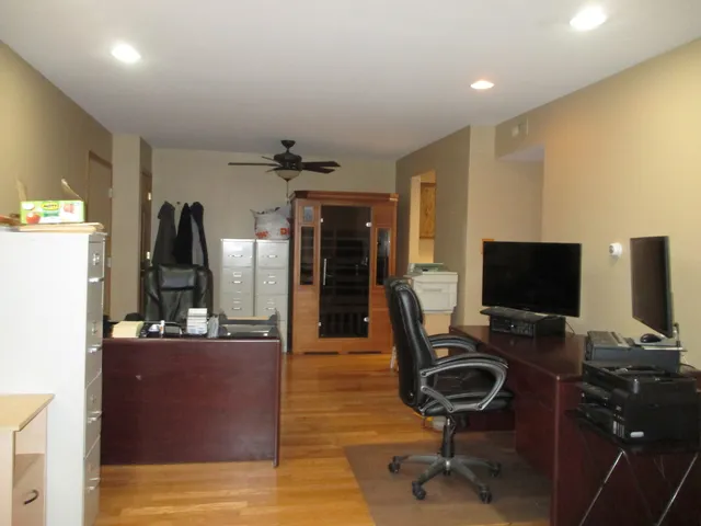 a view of a workspace with furniture and gym equipment