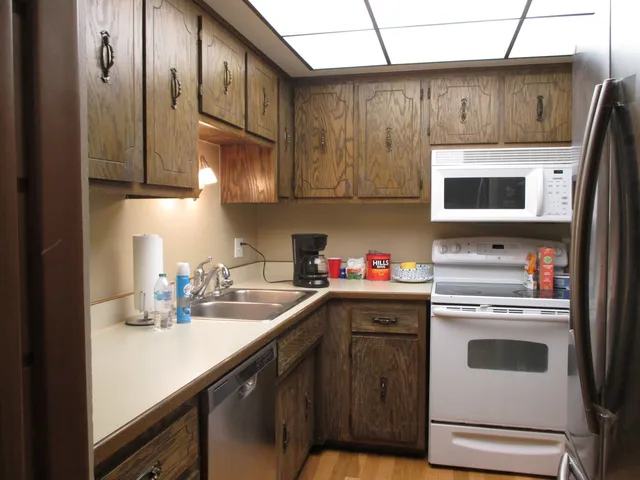 a kitchen with stainless steel appliances granite countertop a sink stove and microwave