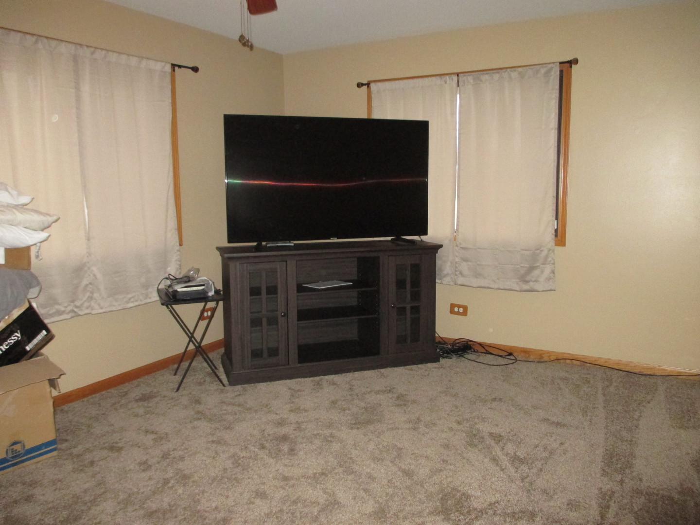 4010 150th Street, Unit 10 Midlothian, IL 60445 - Photo 8 of 13 a living room with a flat screen tv and a refrigerator
