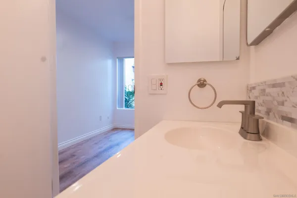 a bathroom with a sink and mirror