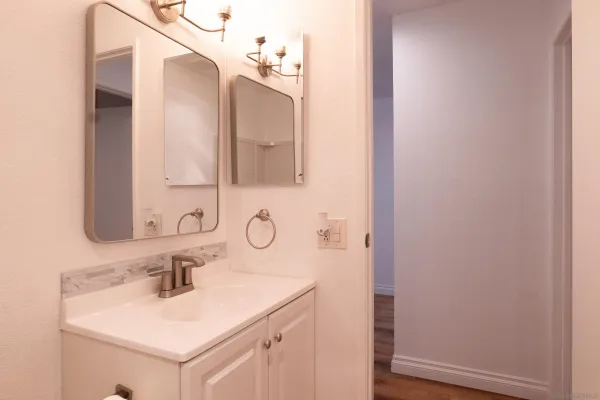 a white toilet sitting next to a shower