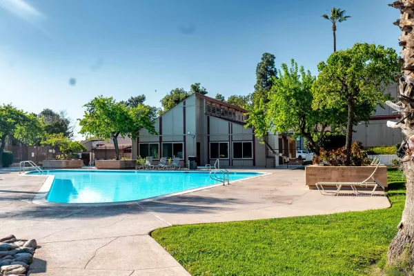 a view of a house with swimming pool and sitting area