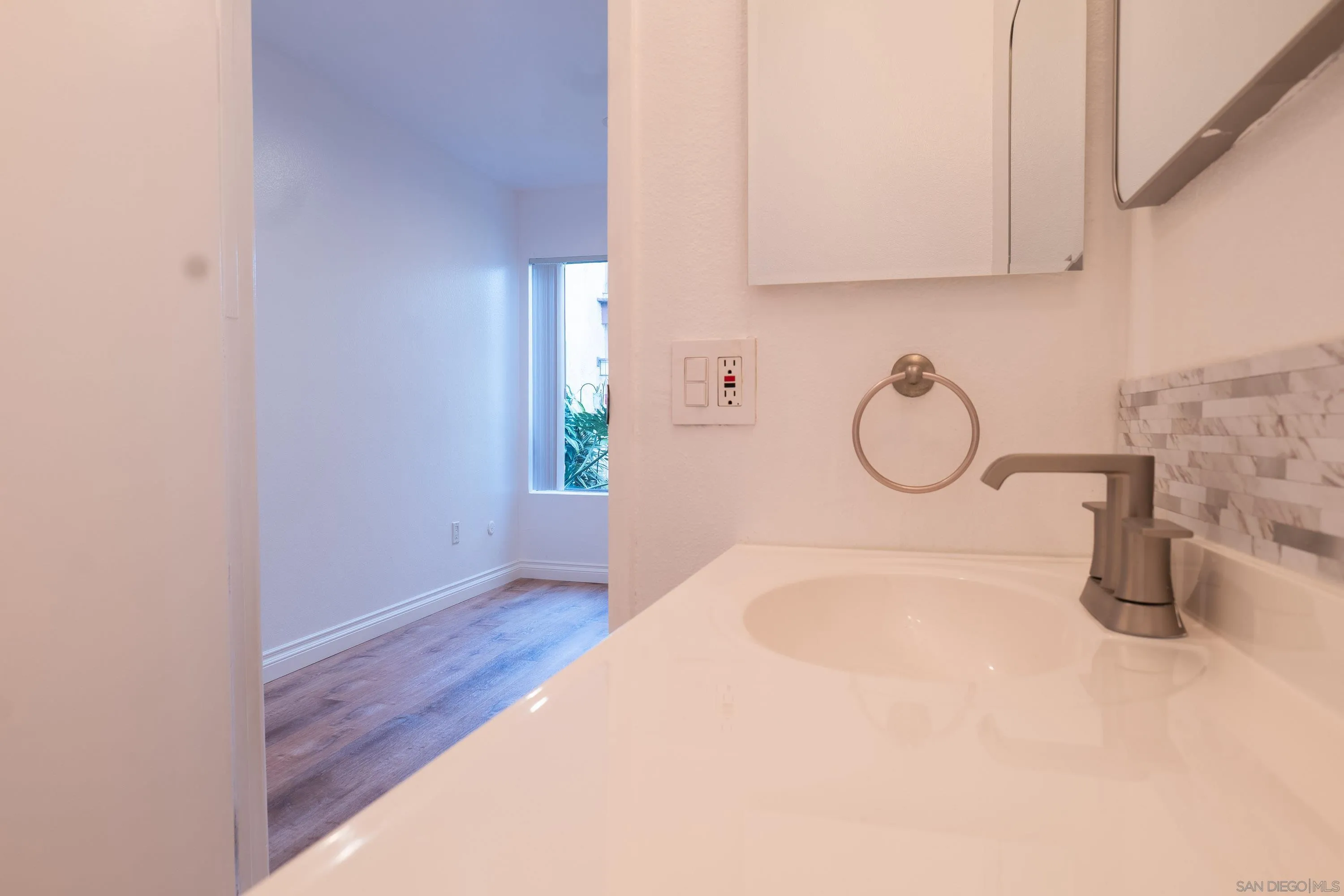 5513 Adobe Falls Road, Unit 2 San Diego, CA 92120 - Photo 26 of 40 a view of a room with wooden floor and cabinets
