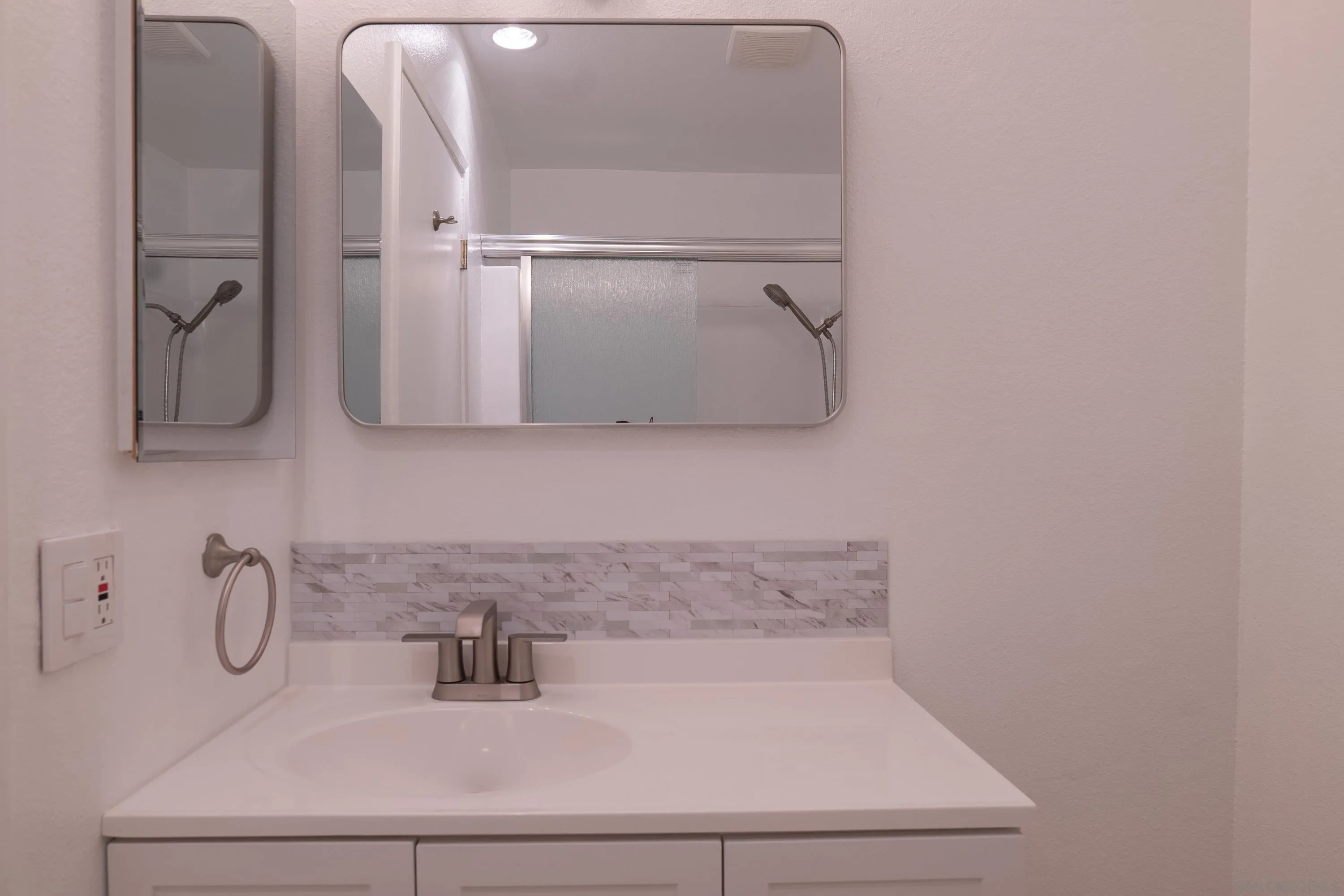 5513 Adobe Falls Road, Unit 2 San Diego, CA 92120 - Photo 27 of 40 a bathroom with a sink and mirror