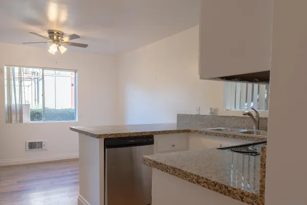 a kitchen with a sink a stove and cabinets