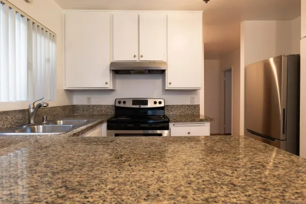 a kitchen with stainless steel appliances a stove a refrigerator and a sink