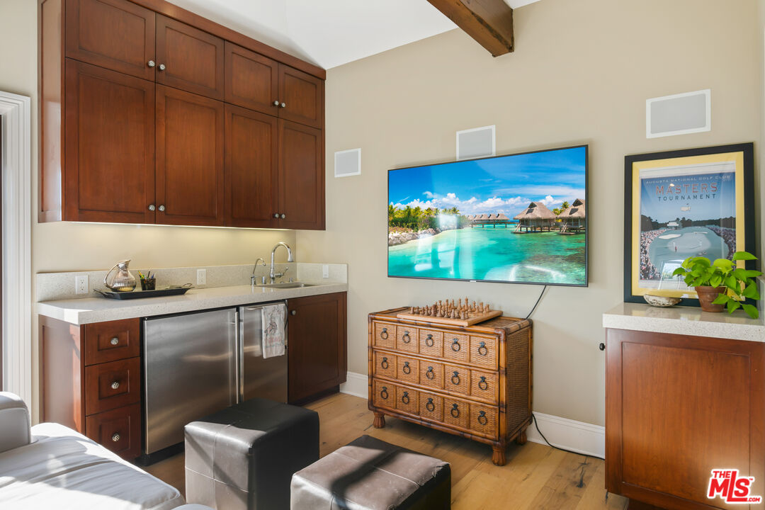 2962 Valmere Drive Malibu, CA 90265 - Photo 19 of 50 a room with furniture and flat screen tv