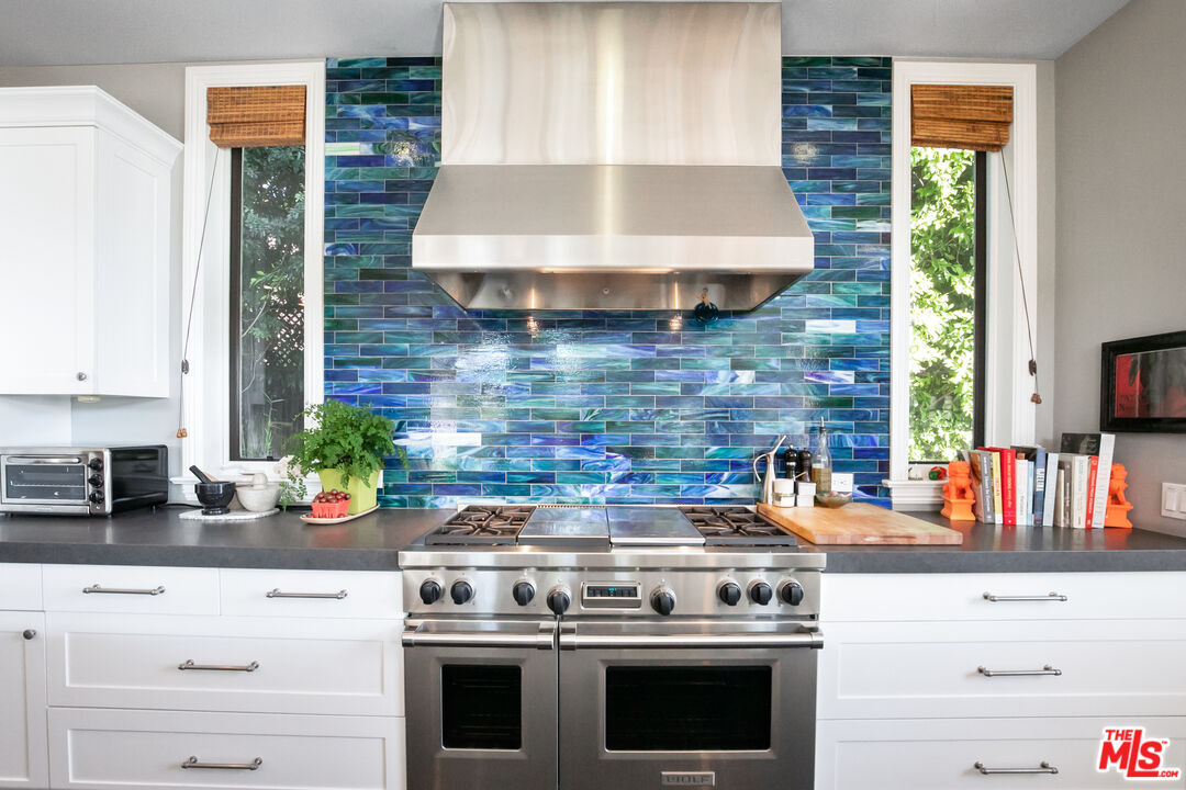 2962 Valmere Drive Malibu, CA 90265 - Photo 6 of 50 a kitchen with stainless steel appliances a stove a sink and a microwave