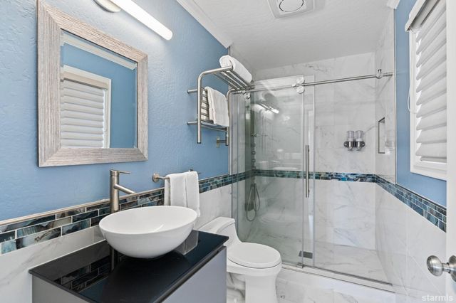 a bathroom with a toilet a sink and shower