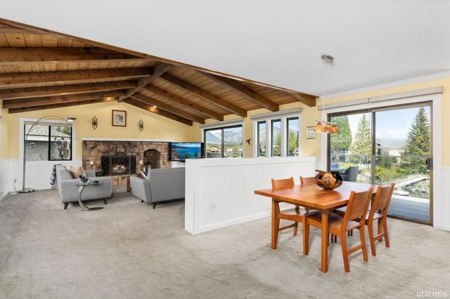 a dining room with furniture and a large window