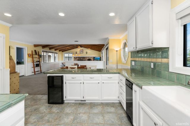 a kitchen with granite countertop a sink and cabinets