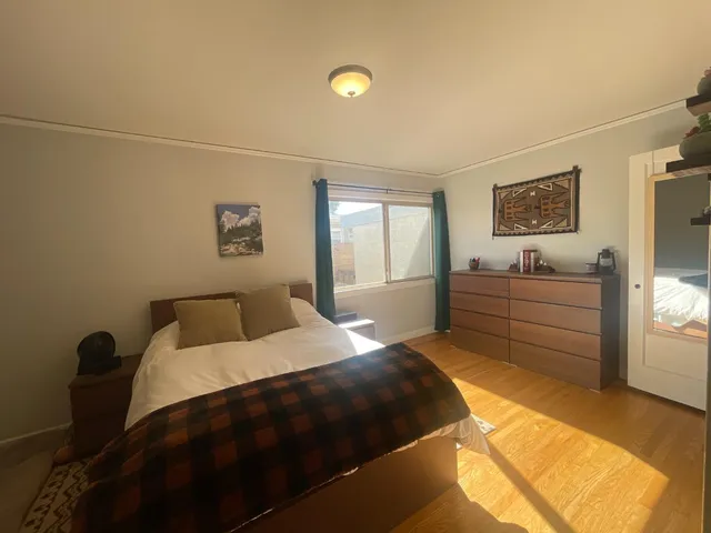 a bedroom with a bed and a window