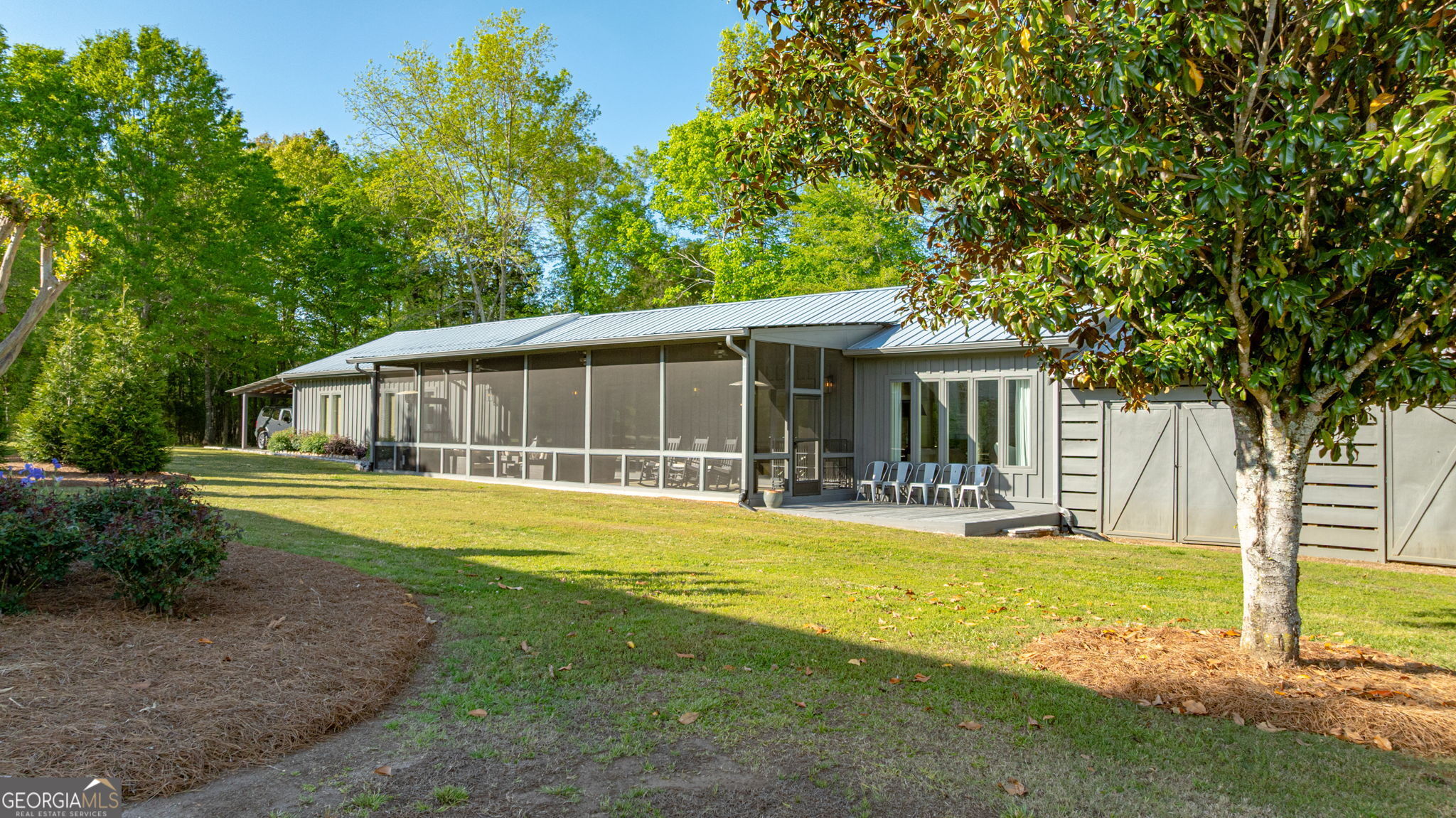 235 Glades Road Eatonton, GA 31024 - Photo 64 of 79 a front view of a house with swimming pool and porch with green space