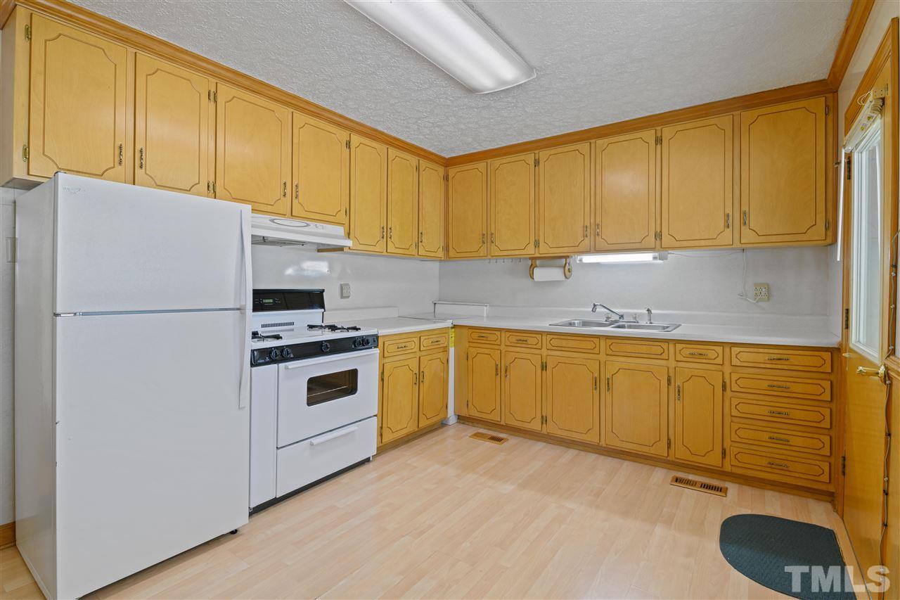 1421 Kelly Road Garner, NC 27529 - Photo 18 of 24 The kitchen was remodeled in the late 70's, it has tall cabinetry that is real wood! Worth saving if another remodel in the the future!