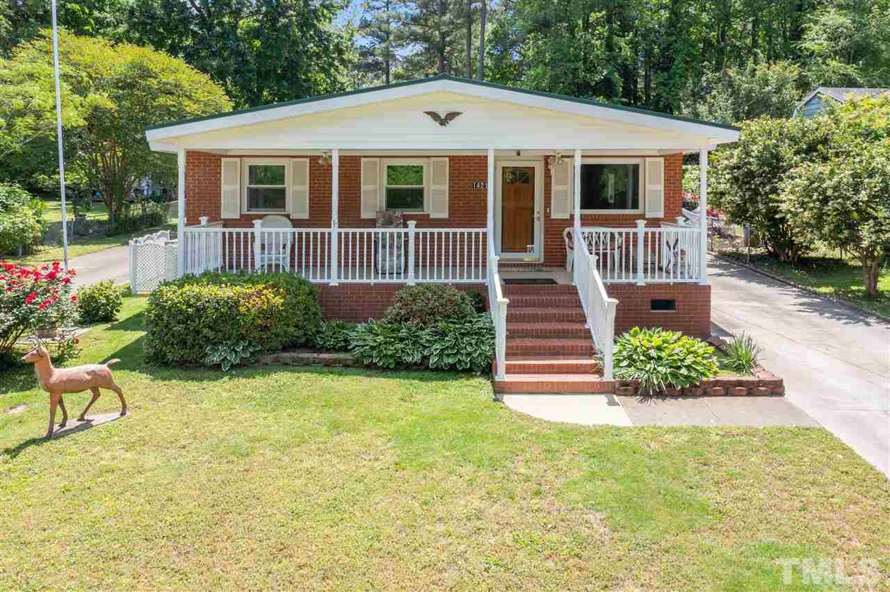 One of the prettiest homes in. the neighborhood, azaieas are on front of the home, rose bushes and hydrangas are also in the landscaping.