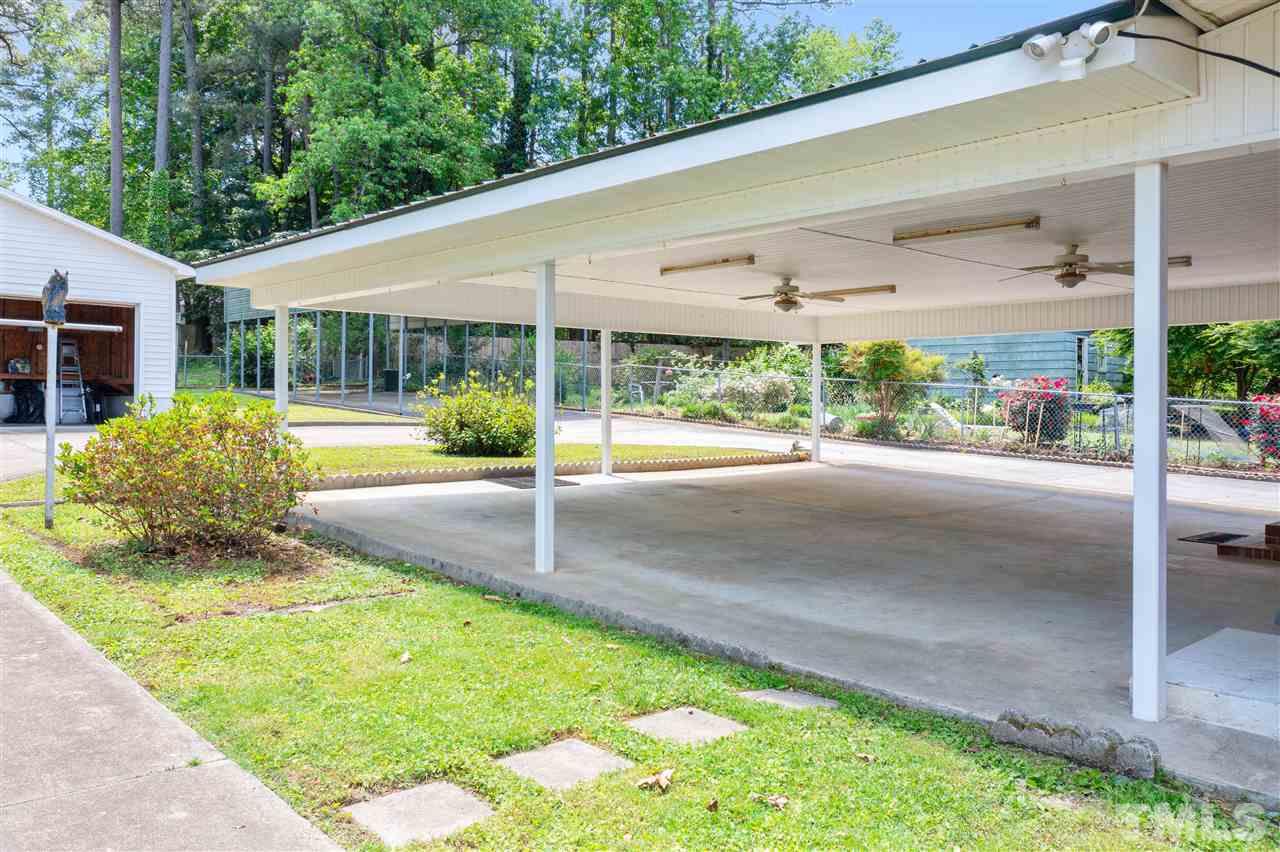 1421 Kelly Road Garner, NC 27529 - Photo 8 of 24 The large carport, complete with ceiling fans can double as an awesome entertaining space !