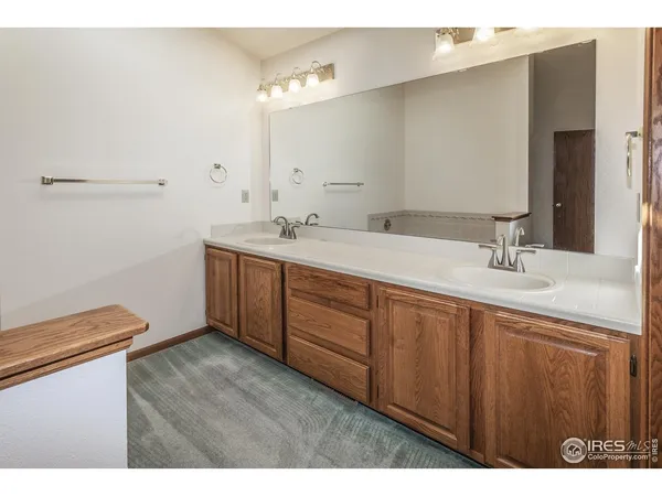 a bathroom with a sink vanity granite and a mirror