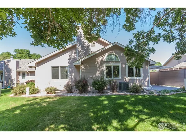 a front view of house with a garden and patio