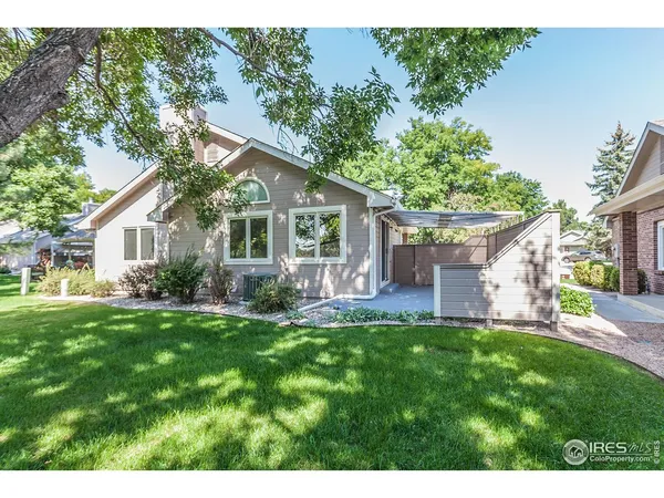 a front view of house with a garden and patio