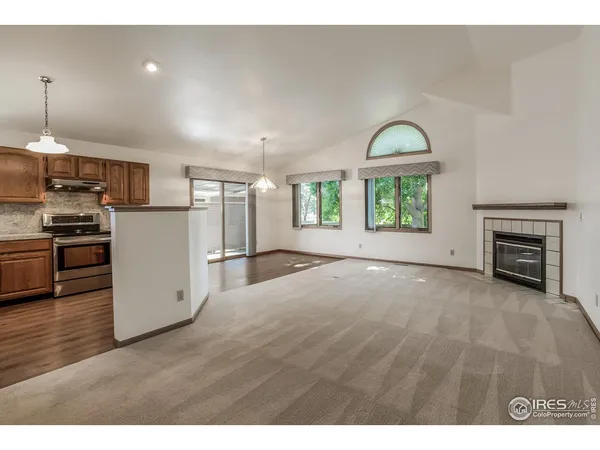 a view of a kitchen with a sink stove cabinets and empty room