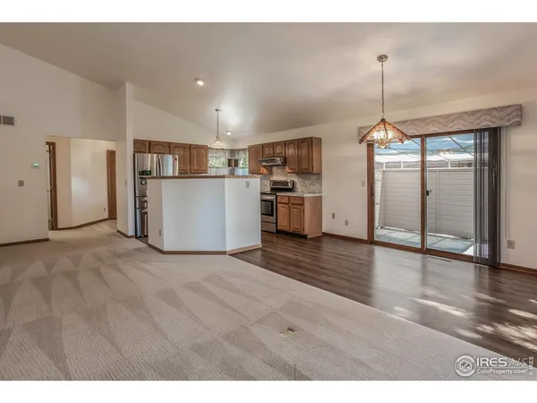 a view of kitchen with furniture and wooden floor