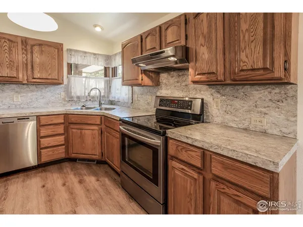 a kitchen with stainless steel appliances granite countertop a sink stove and cabinets