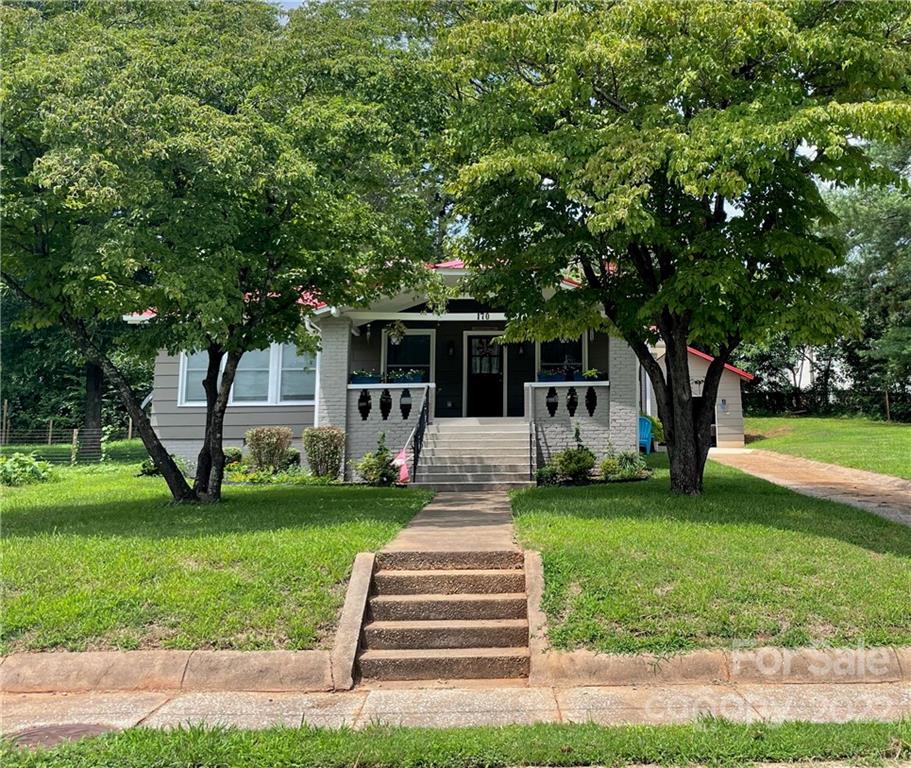 170 South Mitchell Avenue Rutherfordton, NC 28139 - Photo 1 of 21 a front view of a house with garden