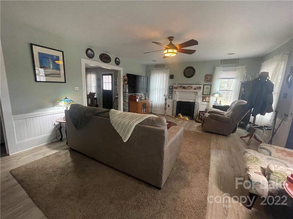 170 South Mitchell Avenue Rutherfordton, NC 28139 - Photo 3 of 21 a living room with furniture a fireplace and a chandelier