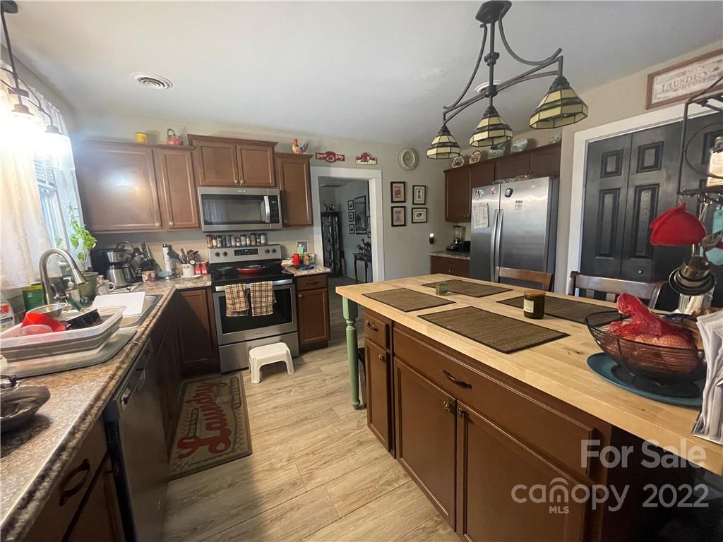 170 South Mitchell Avenue Rutherfordton, NC 28139 - Photo 5 of 21 a kitchen with stainless steel appliances granite countertop a sink stove and refrigerator