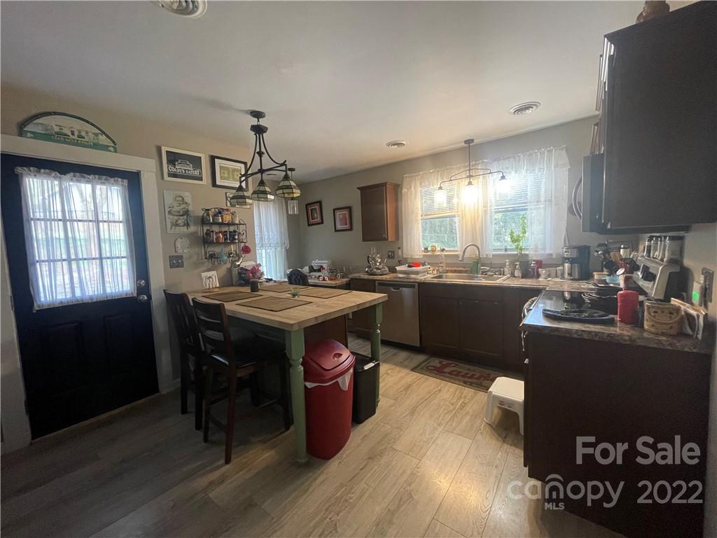 170 South Mitchell Avenue Rutherfordton, NC 28139 - Photo 6 of 21 a kitchen with granite countertop a sink cabinets and wooden floor