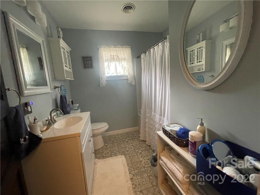 170 South Mitchell Avenue Rutherfordton, NC 28139 - Photo 9 of 21 a bathroom with a toilet sink and mirror