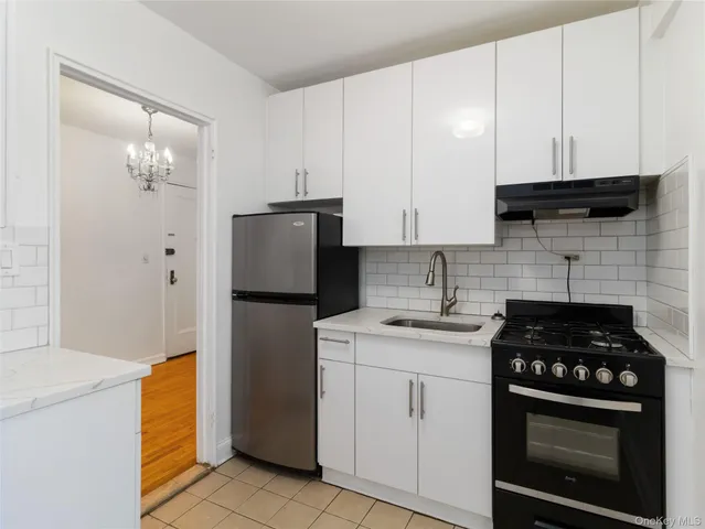 a view of a bedroom with a and white cabinets