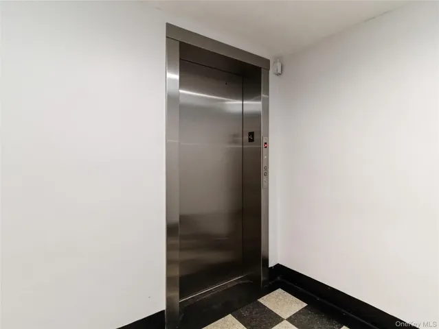 a view of a entryway of a house and livingroom with furniture