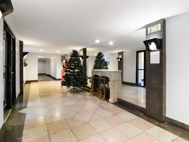 a room with a book shelf and a window