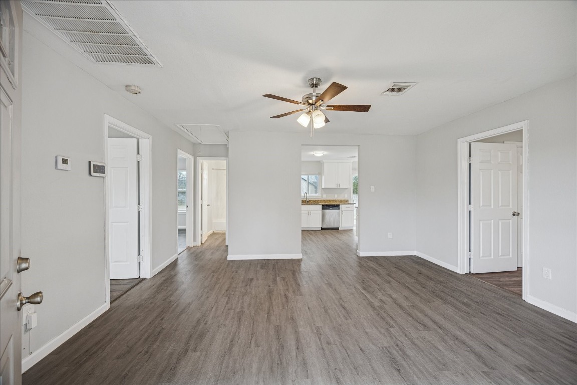5126 Higgins Street Houston, TX 77033 - Photo 5 of 14 a view of a big room with wooden floor and a kitchen