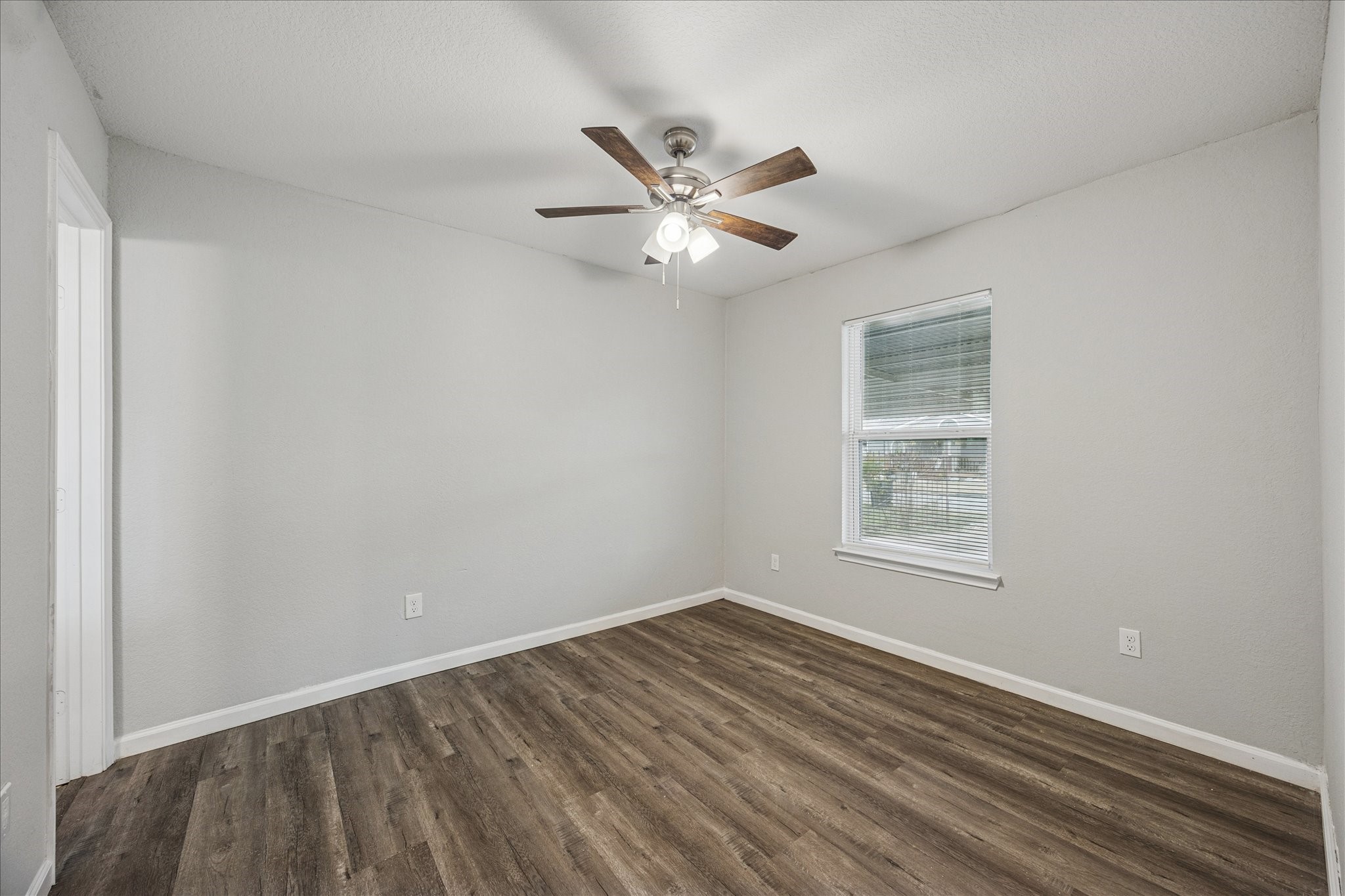5126 Higgins Street Houston, TX 77033 - Photo 8 of 14 wooden floor in an empty room with a window