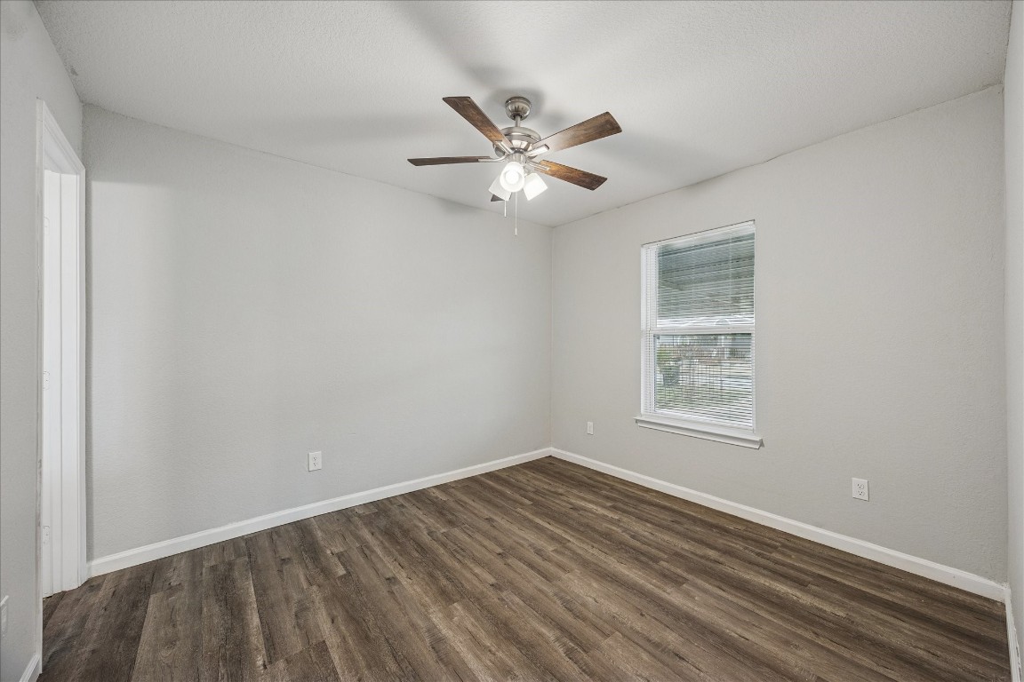 5126 Higgins Street Houston, TX 77033 - Photo 8 of 14 wooden floor in an empty room with a window