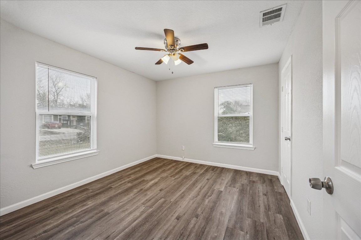 5126 Higgins Street Houston, TX 77033 - Photo 10 of 14 a view of empty room with wooden floor and fan