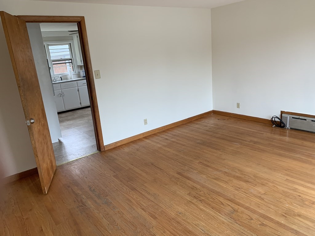 1145 Boston Road Springfield, MA 01119 - Photo 8 of 19 an empty room with wooden floor and mirror