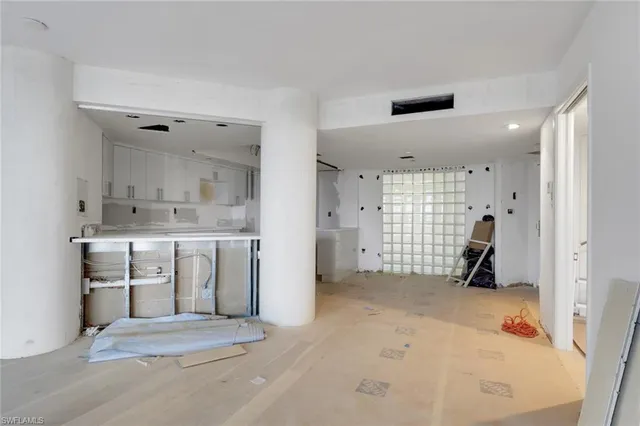a view of kitchen with cabinets and window
