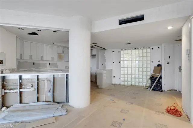 a view of a kitchen with fridge and wooden floor