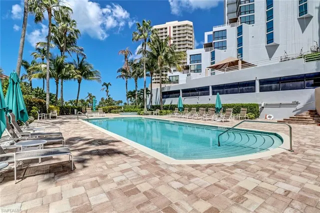a view of swimming pool with outdoor seating and yard