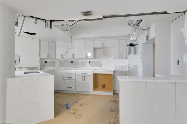 a kitchen with cabinets appliances and a counter top space