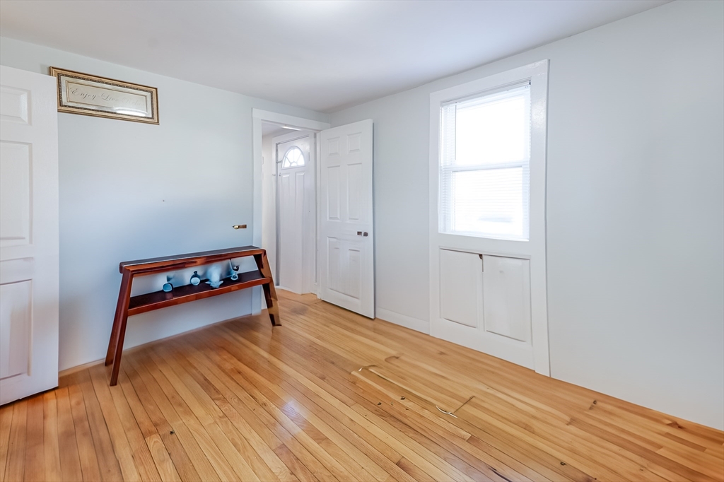 5 Oliver Street Randolph, MA 02368 - Photo 21 of 29 an empty room with wooden floor and windows