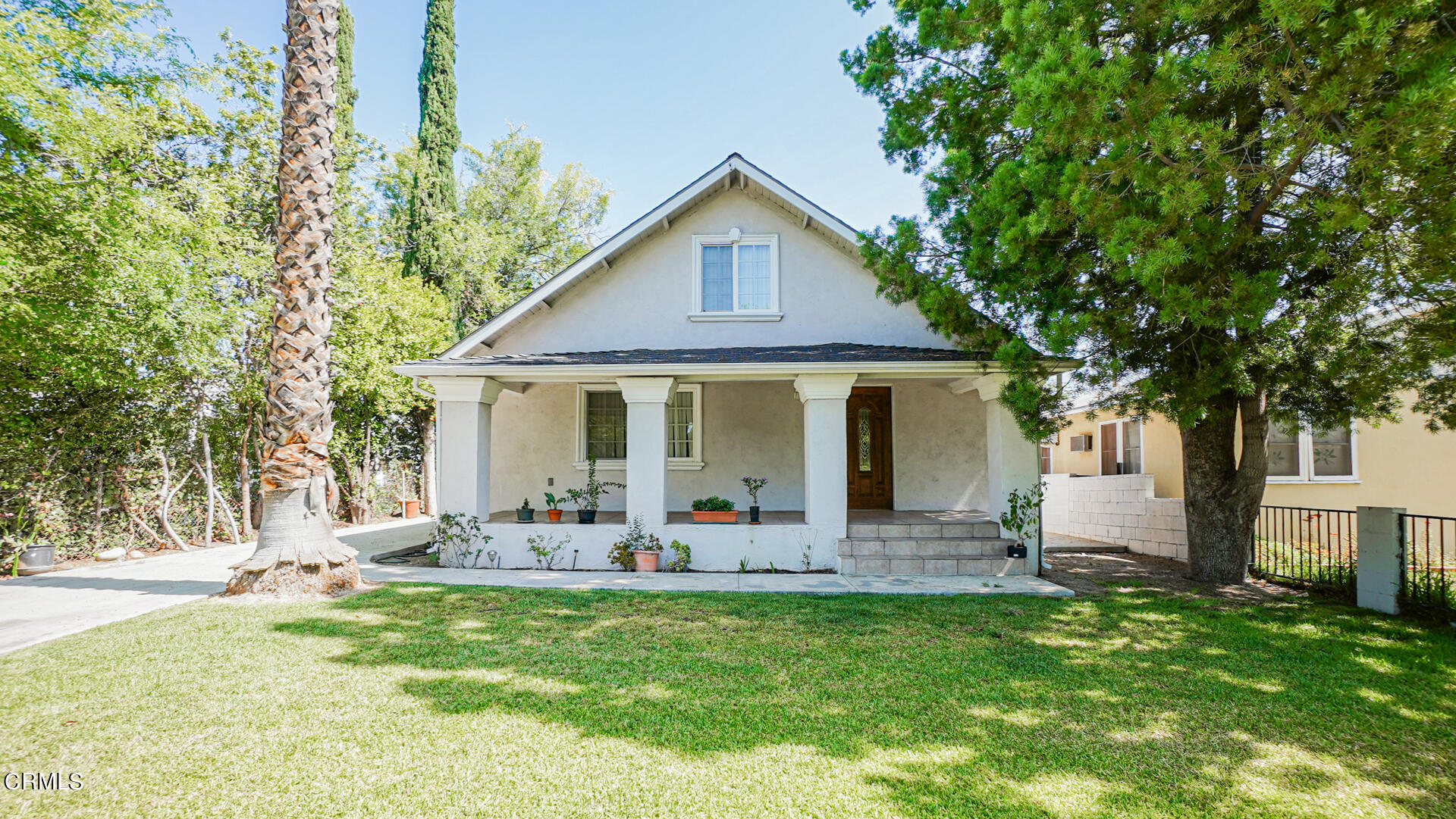 a front view of house with yard and green space